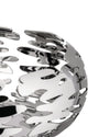 Silver-toned metallic bowl by Alessi with an intricate, flame-like cut-out pattern, cropped view.