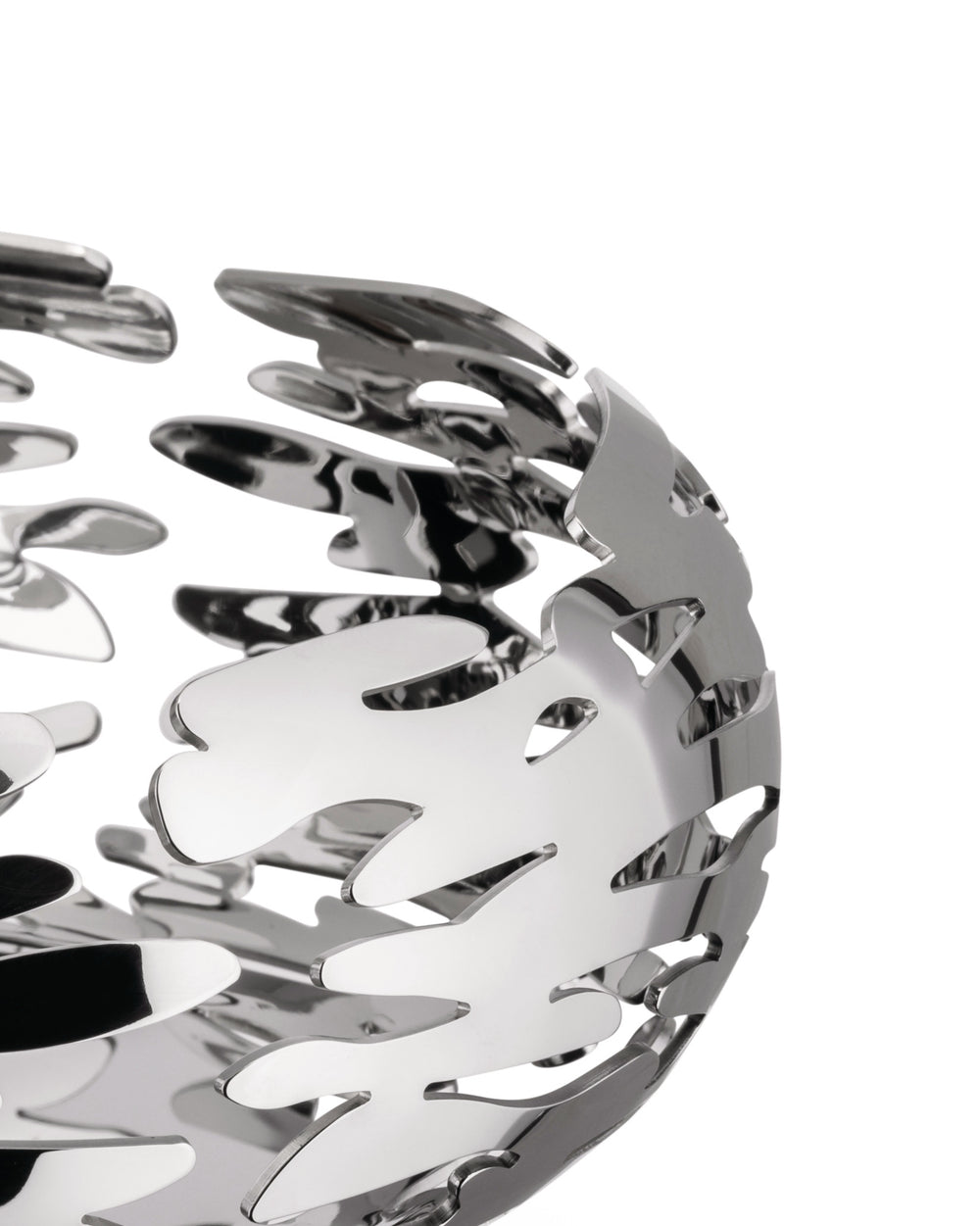 Silver-toned metallic bowl by Alessi with an intricate, flame-like cut-out pattern, cropped view.