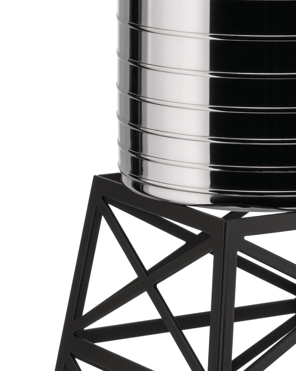 Silver polished Water Tower by Alessi with grooved cylinder on a black geometric stand, close-up.