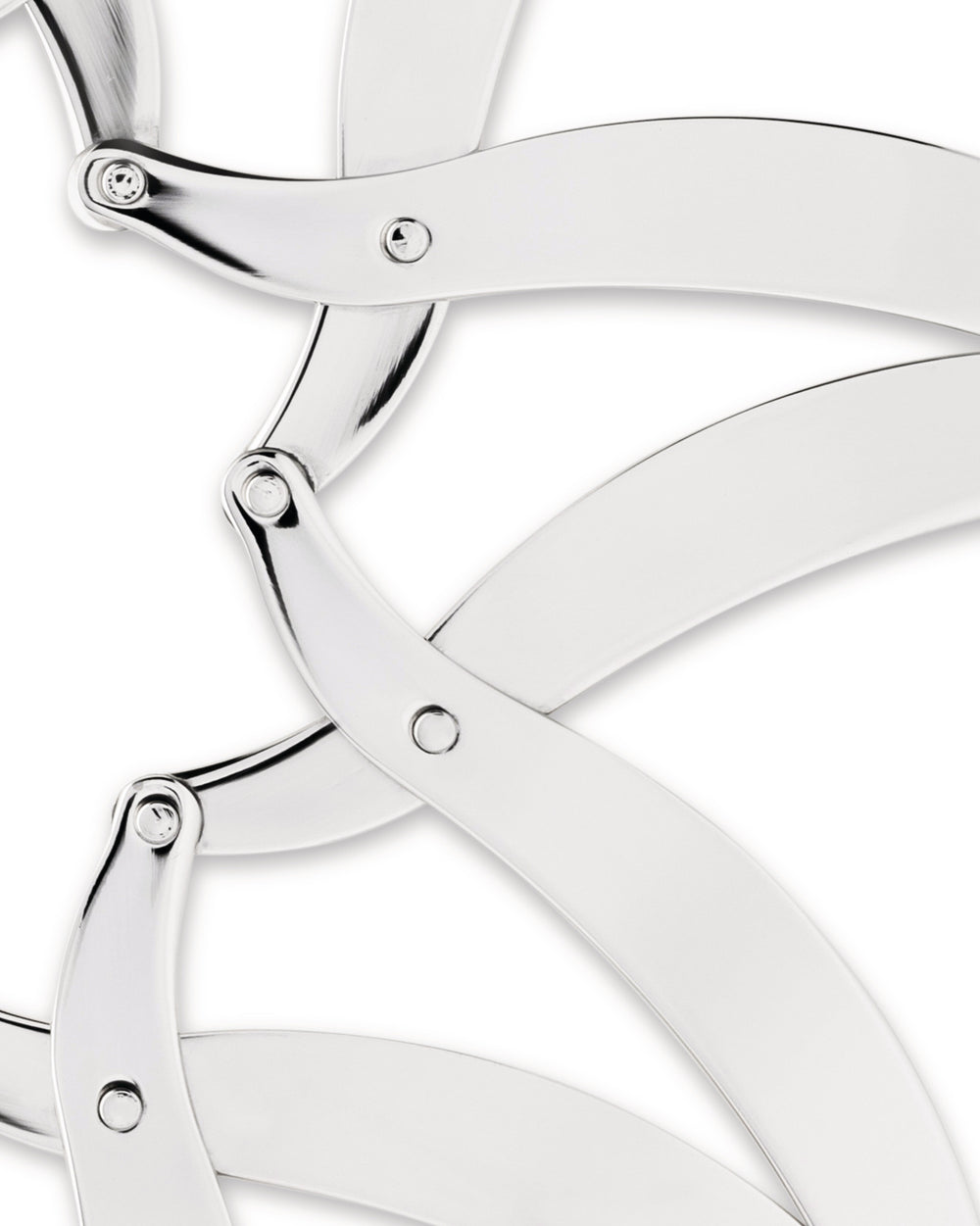 Silver metal trivet by Alessi, featuring interlocking curved arms with a shiny, reflective surface, cropped close-up.
