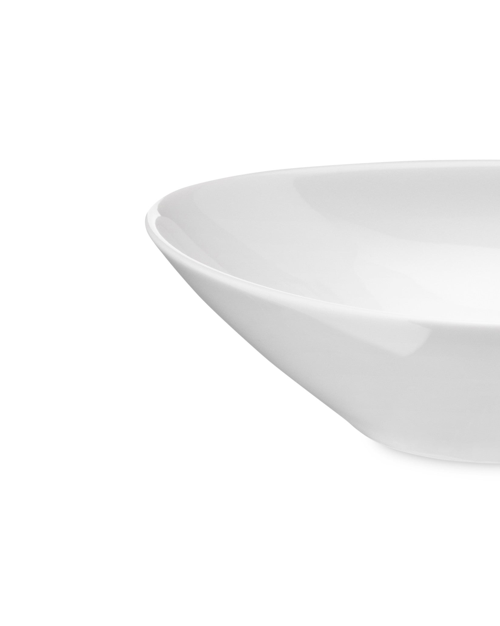 White bowl by Alessi with a smooth, glossy surface, shown in a cropped side view.