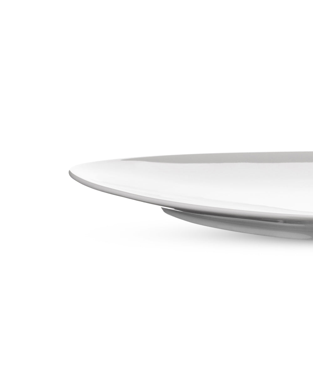 White ceramic dinner plate by Alessi, with a shallow profile and subtle raised edge, cropped view.
