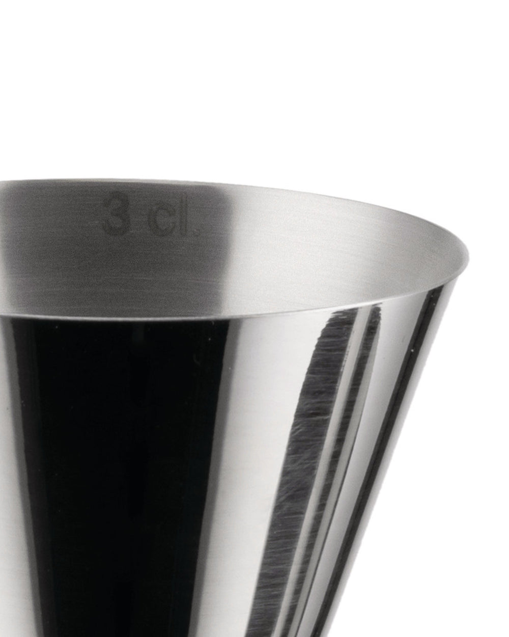Close-up of a silver metallic jigger by Alessi with '3 cl' marking and reflective, brushed texture.