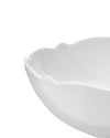 White glossy serving bowl by Alessi with a wavy, scalloped rim, angled view.