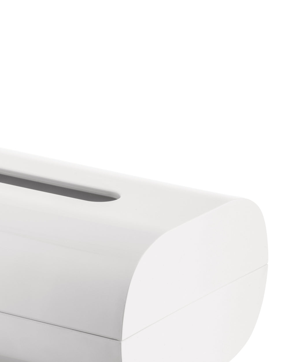 White tissue box holder by Alessi with a sleek, curved top and elongated slot, cropped.