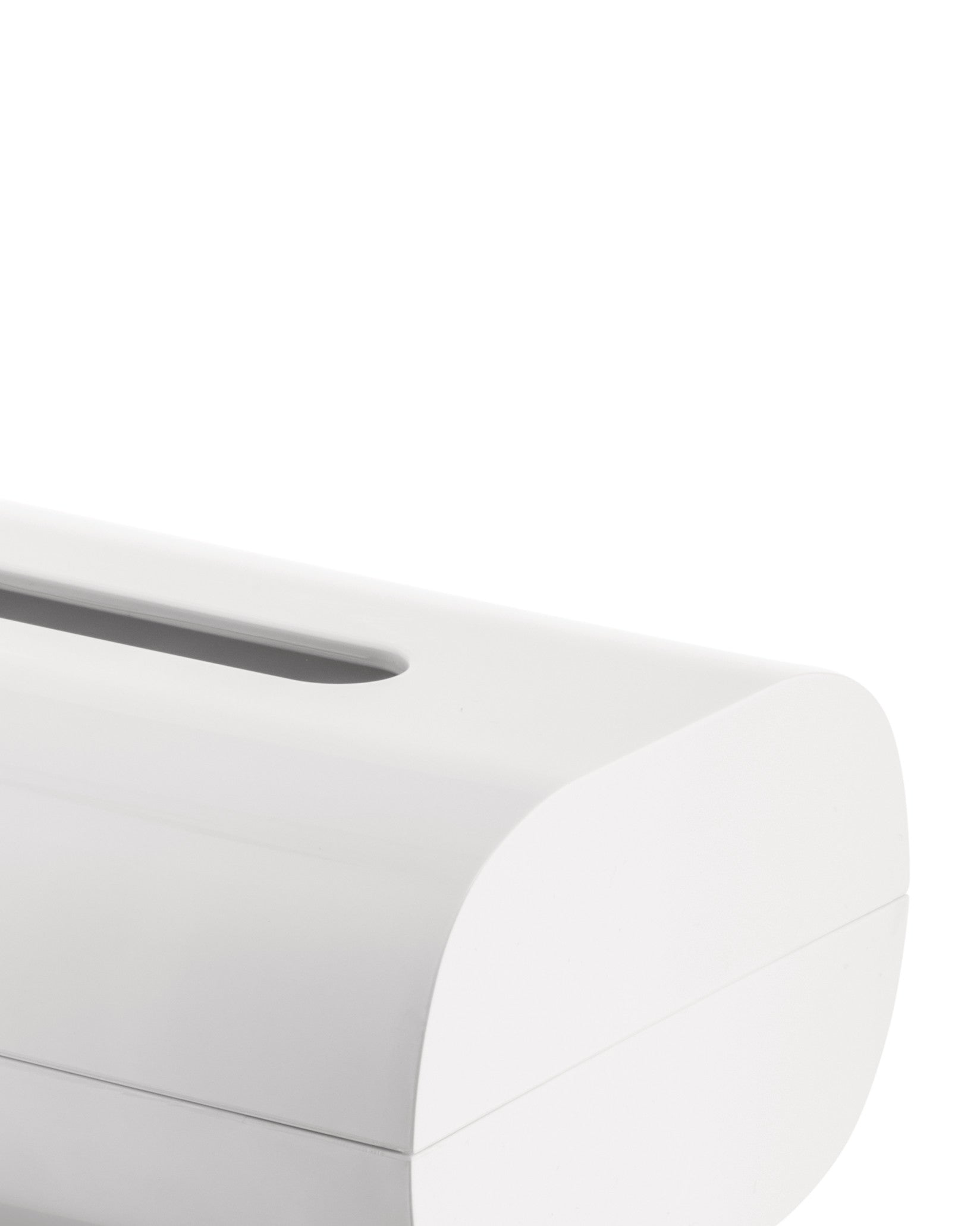 White tissue box holder by Alessi with a sleek, curved top and elongated slot, cropped.