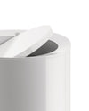 Glossy white modern container by Alessi with its round lid partially open, revealing a dark interior.