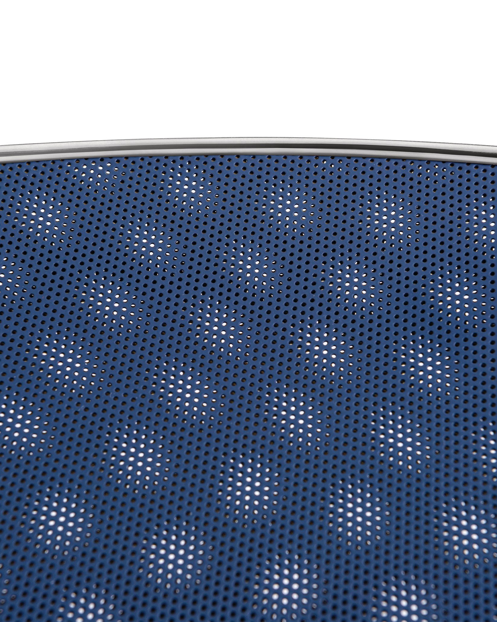 Blue Cohncave by Alessi, a perforated bowl with a silver metallic rim, revealing a white background through its small holes.
