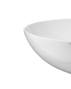 White glossy Mami bowl by Alessi with elegant curved lines, shown in a cropped view.