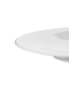 Cropped view of a minimalist white plate by Alessi, featuring a smooth, glossy surface and curved edge.