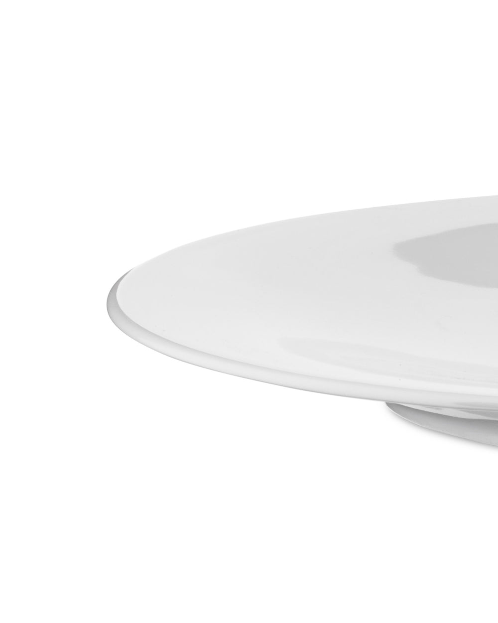 Cropped view of a minimalist white plate by Alessi, featuring a smooth, glossy surface and curved edge.