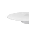White plate by Alessi with a smooth, glossy surface, captured from a low, cropped side angle.