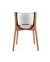 Natural wood chair with a shiny chrome backrest by Alessi, featuring a distinctive curved shape, viewed from the back.