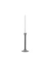Industrial metal candle holder by Alessi, featuring a threaded rod, hexagonal nut, round base, and a white candle.