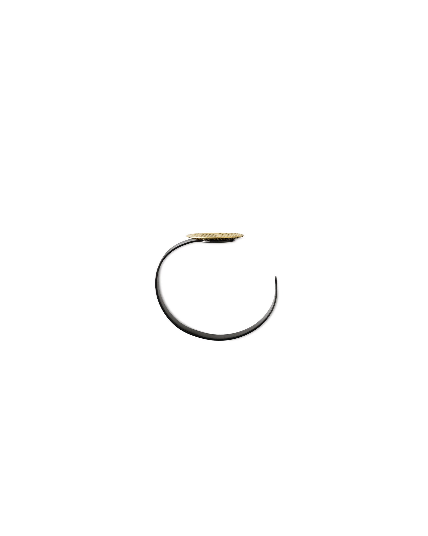 Black and gold decorative bowl by Alessi, featuring a curved C-shaped base and a textured gold disc.