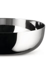 Silver metallic bowl by Alessi, cropped, reflecting abstract dark and white patterns.