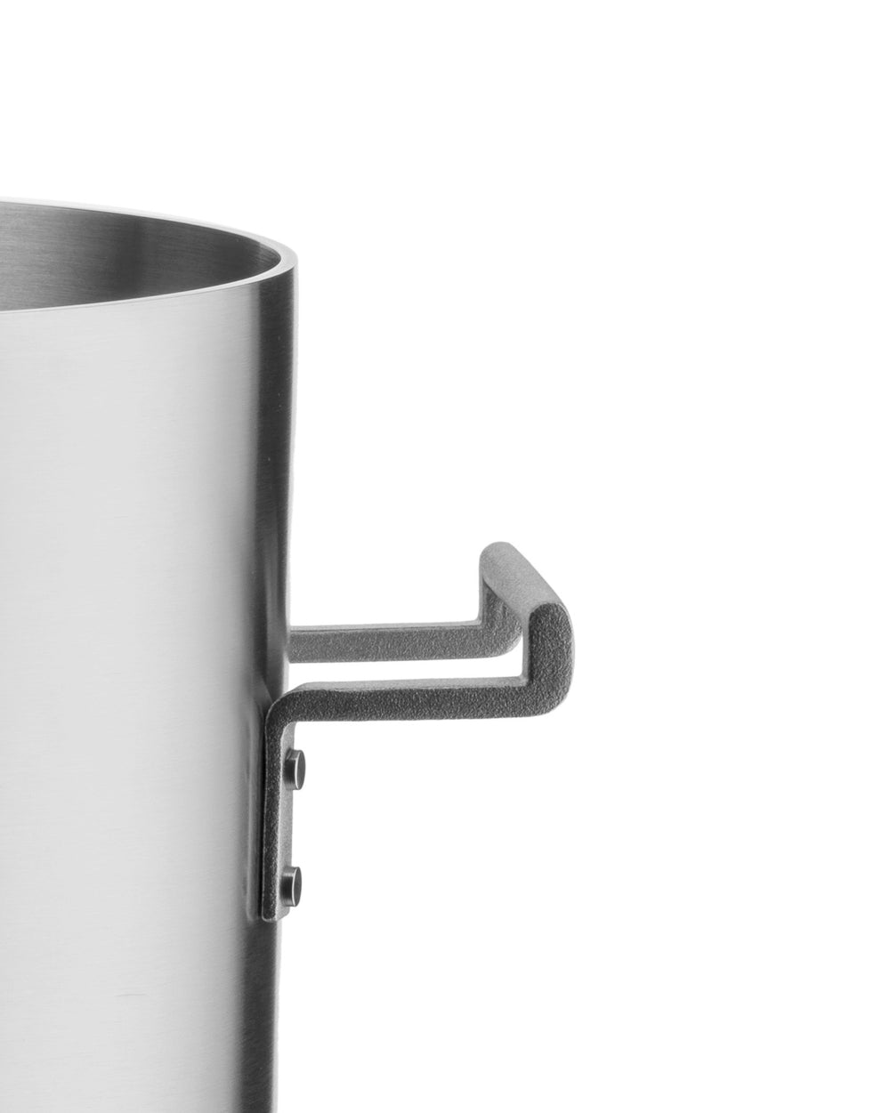 Silver brushed stainless steel pot by Alessi with dark grey L-shaped handles, cropped side view.