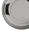 Round silver metal serving tray by Alessi with concentric ridges and a reflective surface, cropped.