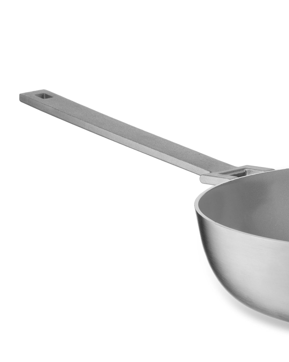 Silver brushed metal pan by Alessi with a flat rectangular handle and square cut-out, cropped side view.