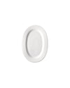 White oval plate by Alessi with a gently sloped rim and recessed serving area, top view.