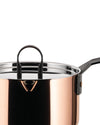 A copper casserole by Alessi with a stainless steel lid and black handle, shown in a cropped view.