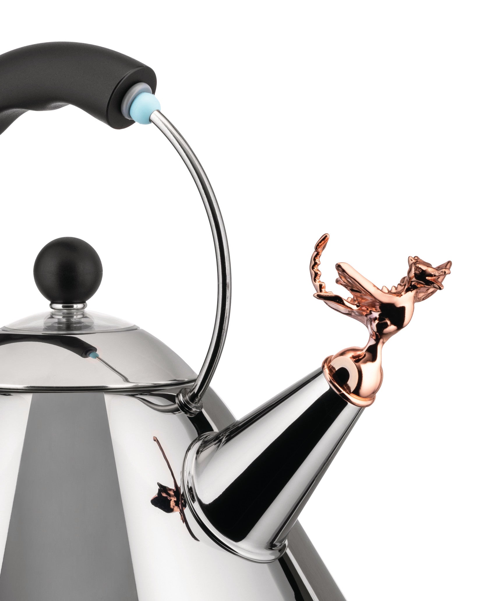 Polished stainless steel tea kettle by Alessi with a black handle, knob, and decorative copper-toned dragon whistle.