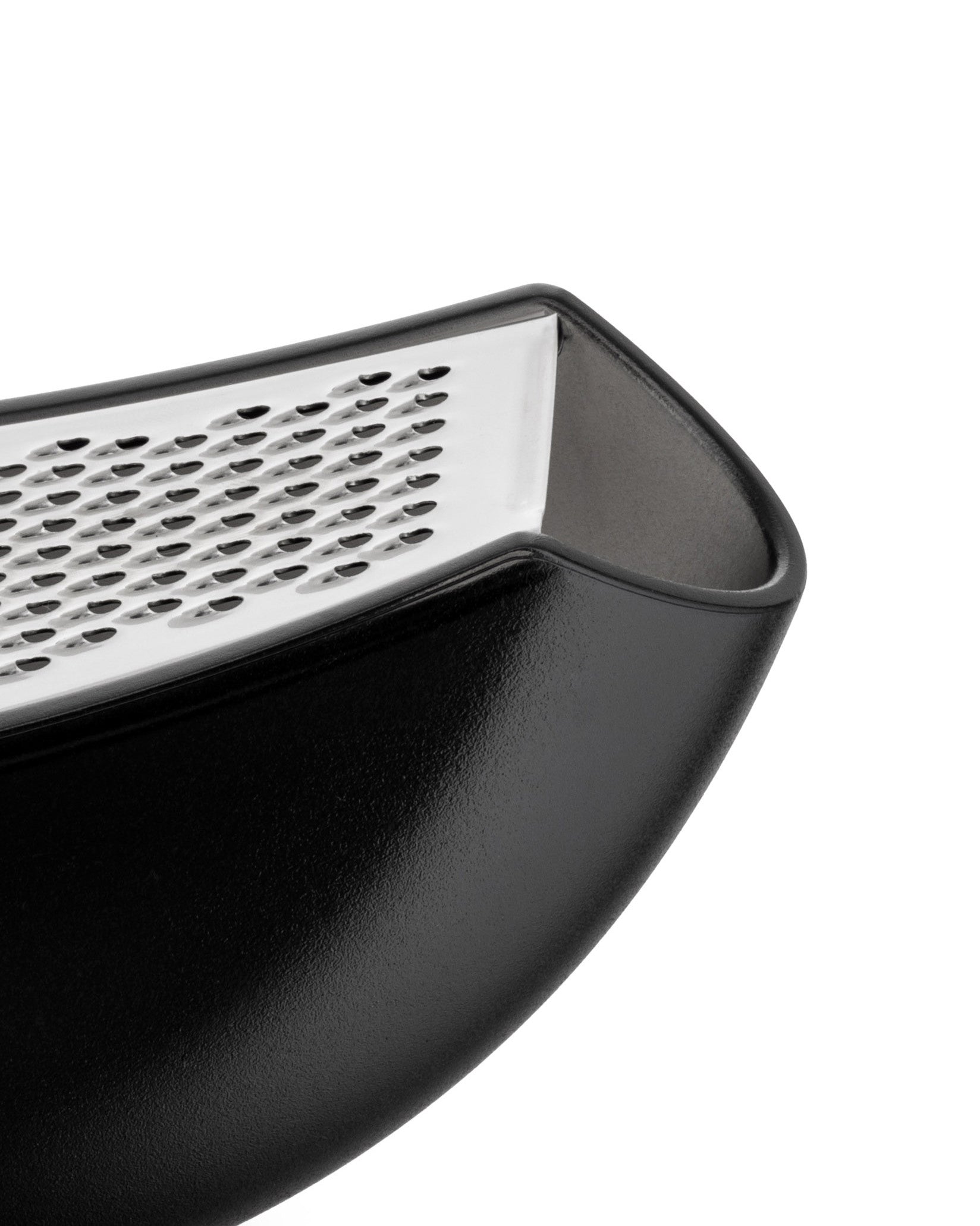 Black and silver grater by Alessi with a textured, curved body and perforated metal grating surface, shown cropped.