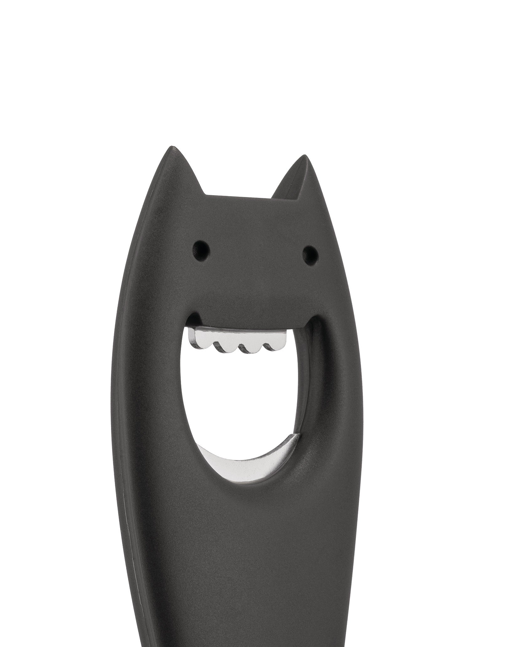 Black bottle opener by Alessi, shaped like a smiling bat head with pointy ears and jagged metal teeth.