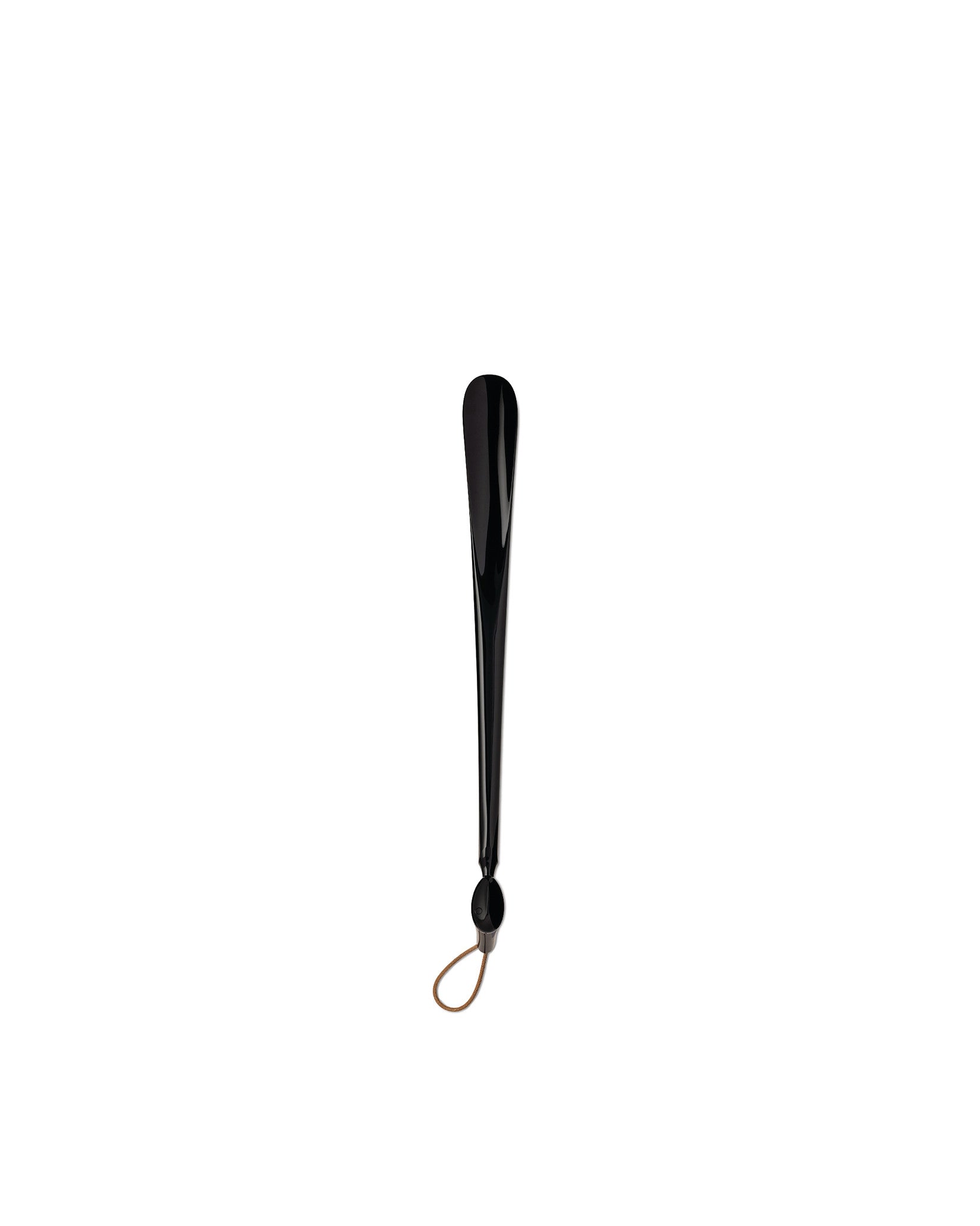 Black shiny shoehorn by Alessi with a brown leather loop at the base.