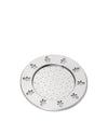 Round silver metal plate by Alessi, featuring little man cutouts on the rim and a perforated center.