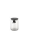 Clear glass storage jar by Alessi with black lid and a small black figure holding tight inside.