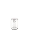 Clear glass storage jar by Alessi with a white lid and a small white figure hanging inside.