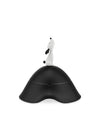 Black lidded jar by Alessi with a white dog figurine on top and an undulating base.