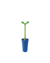 Green toilet brush by Alessi, with a plant-like handle, in a blue holder with a red interior.