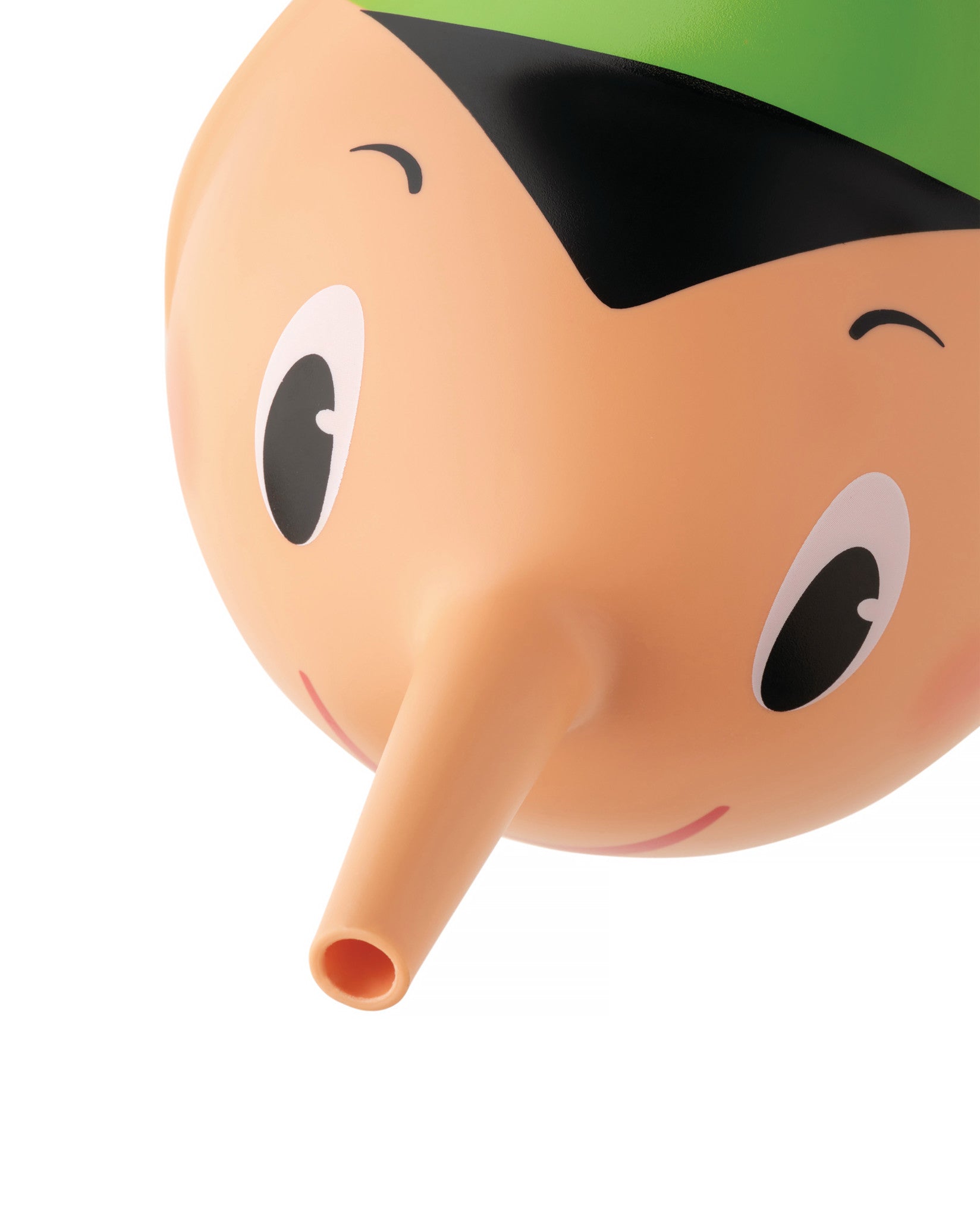 Peach-toned Pino watering can by Alessi with a long spout nose, green cap, and cartoon facial features.