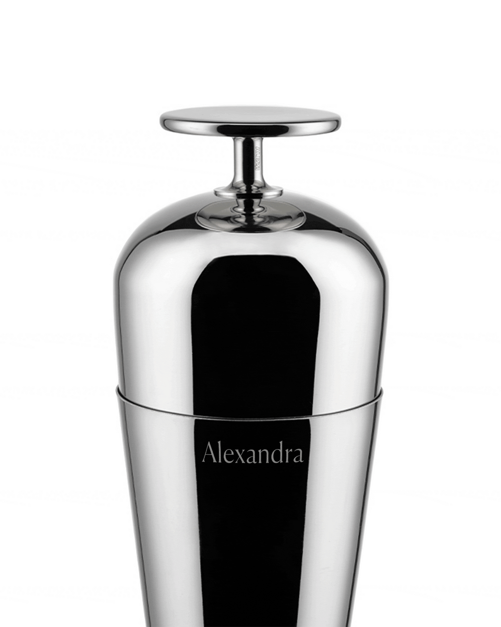 Sleek silver cocktail shaker by Alessi, with a flat top and "Alexandra" engraved on its body.
