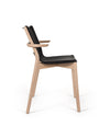 Black and wood chair by Alessi with curved armrests and a sleek design, shown in side view.