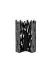 Black metallic decorative holder by Alessi with a vertical bark-like cut-out pattern on a white background.