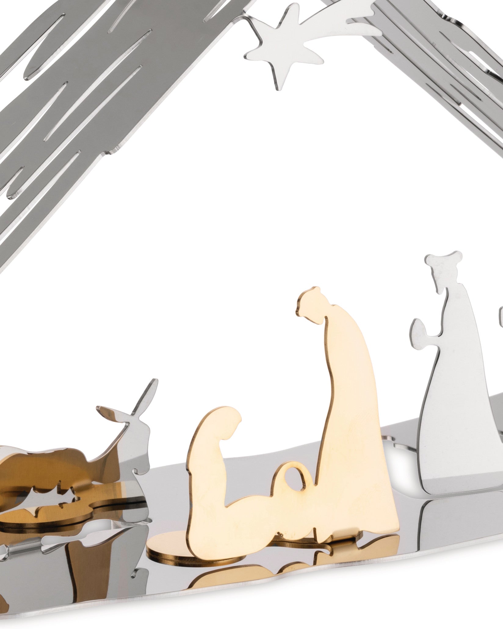 Metallic decorative nativity scene by Alessi, featuring abstract silver and gold figures including a striking golden flexed arm representing Baby Jesus, under a star-cut roof.