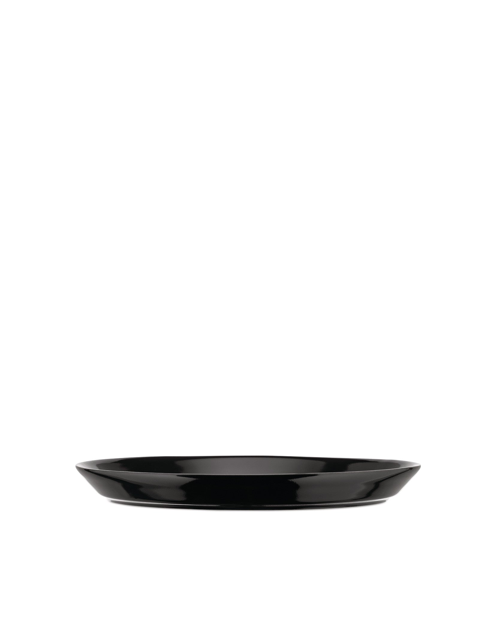 Black shallow serving plate by Alessi with a glossy finish and subtly curved sides.