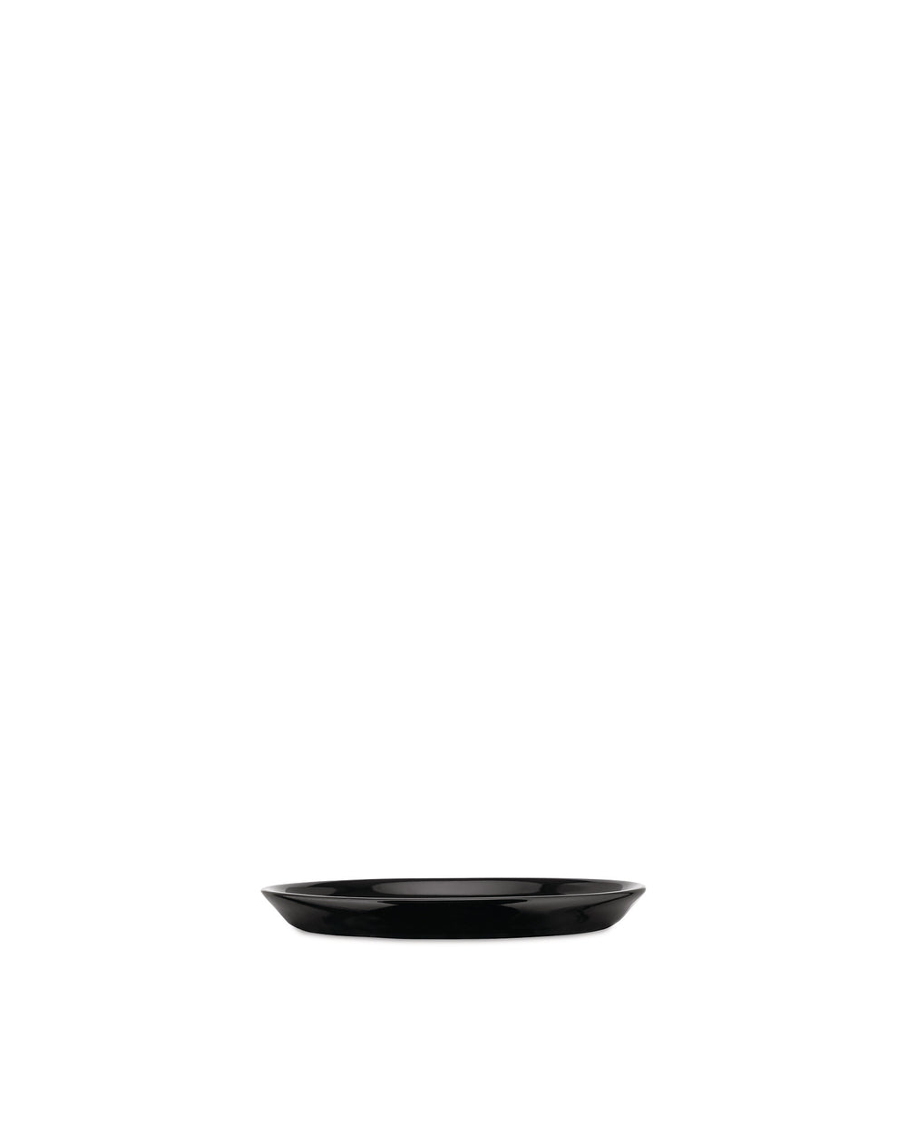 Black oval dish by Alessi with a glossy finish and thin white rim on a white background.