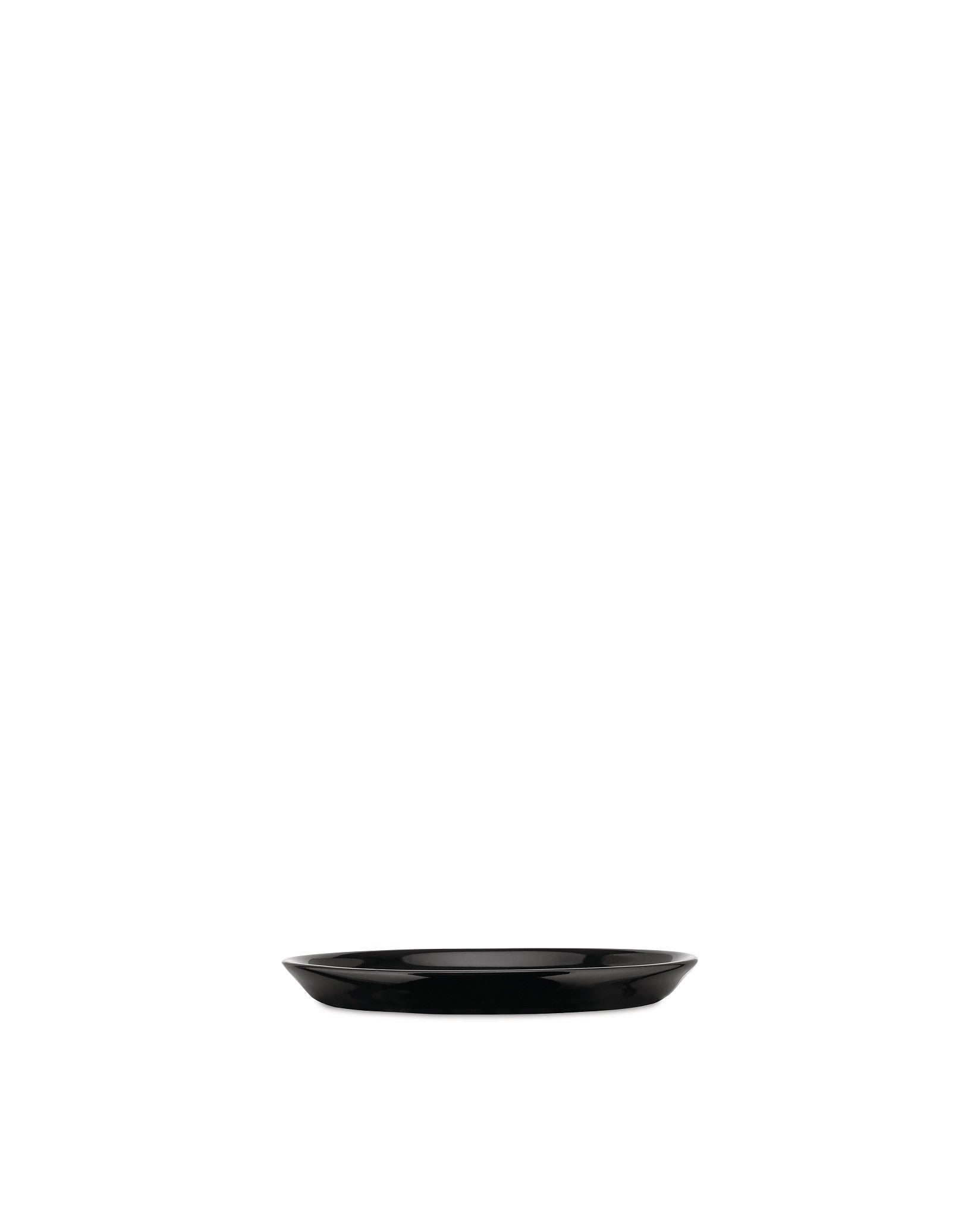 Black oval dish by Alessi with a glossy finish and thin white rim on a white background.