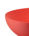 Red bowl by Alessi with a dimpled interior texture, cropped.