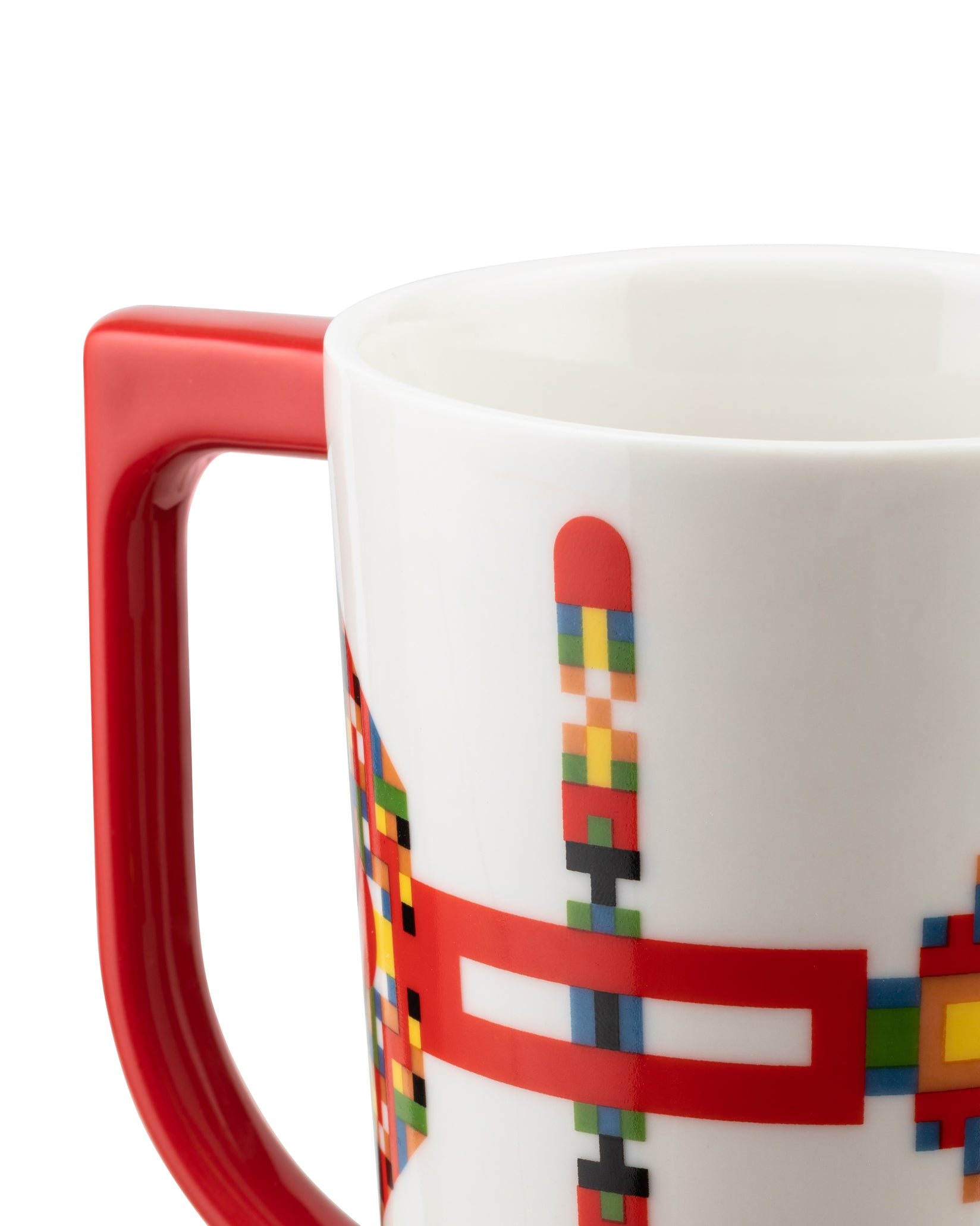 White ceramic mug with a red handle by Alessi, featuring a colorful pixelated geometric design.
