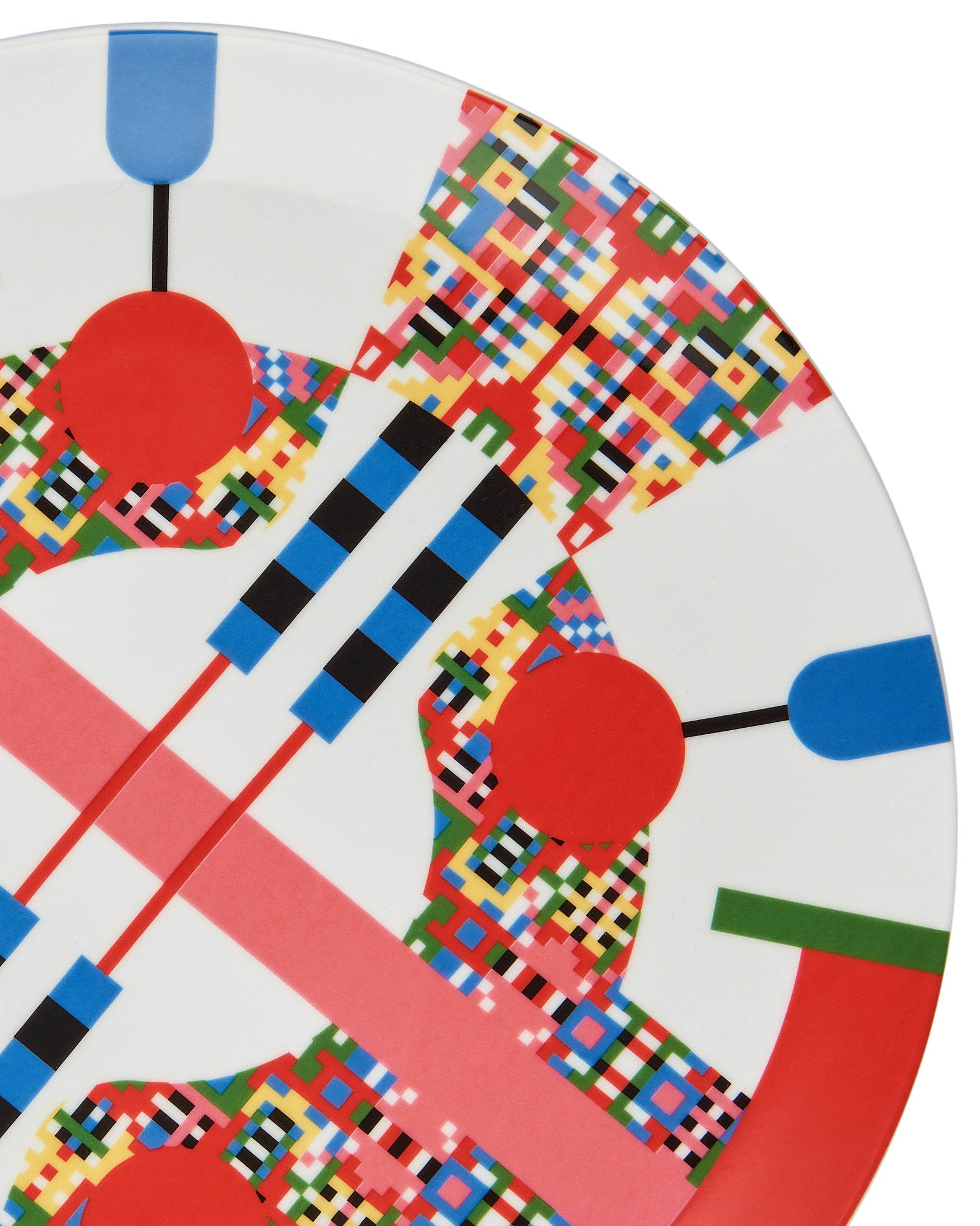 A white decorative plate by Alessi, featuring a vibrant, pixelated geometric pattern of colorful squares, circles, and lines, in a cropped view.
