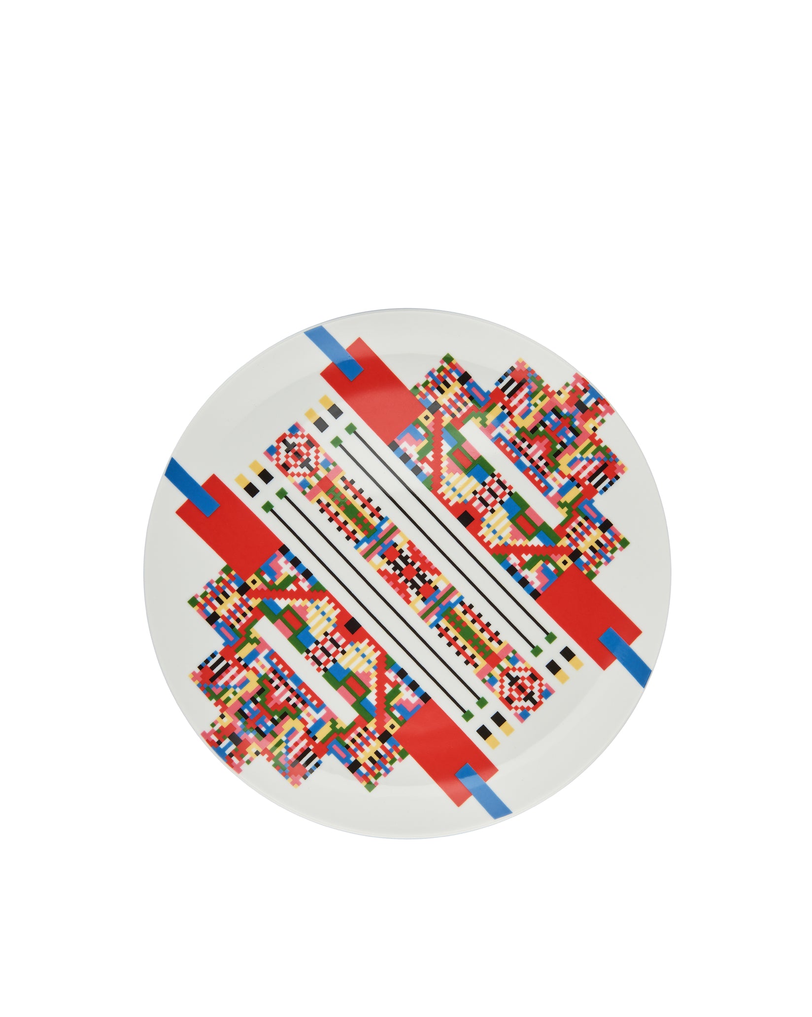 White round plate by Alessi with a vibrant geometric pixelated pattern and bold red and blue lines.