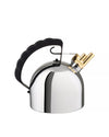 Polished silver stovetop kettle by Alessi with a black sculpted handle and a gold-toned whistle spout.