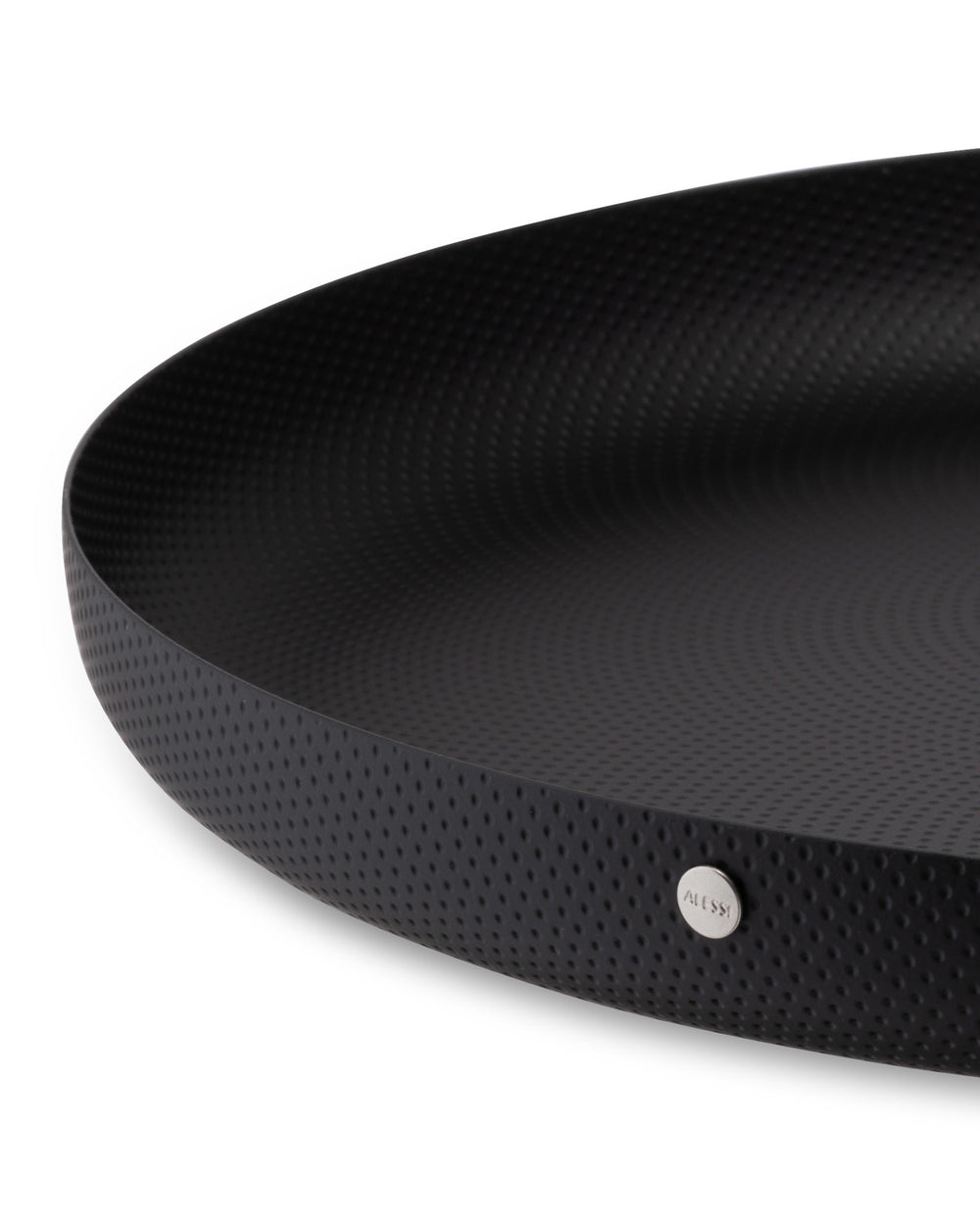 Black round shallow dish by Alessi, with a dimpled matte texture and a silver brand plaque.