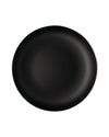 Black round plate by Alessi with a textured dimpled surface and thin white rim.