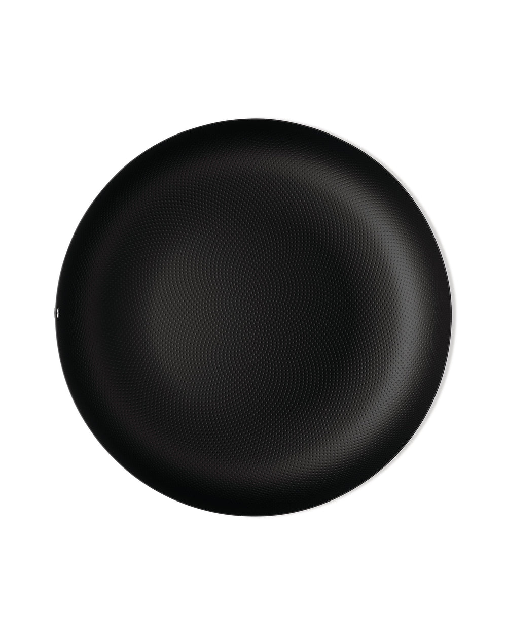 Black round plate by Alessi with a textured dimpled surface and thin white rim.